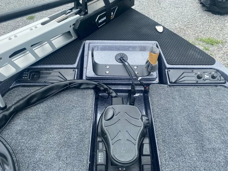 Slide: The Image of 2026 Phoenix 721 ZXL boat deck with Minn Kota trolling motor and control panel. - 16