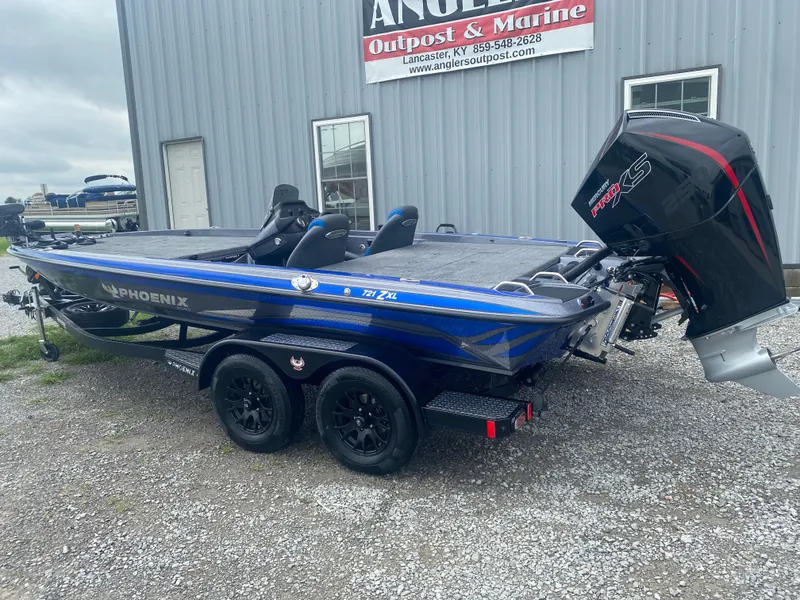 Slide: The Image of 2026 Phoenix 721 ZXL boat with Mercury Pro XS engine, parked outside Angler's Outpost & Marine. - 7