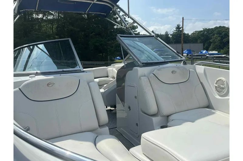 Slide: The Image of 2006 Crownline 230 LS boat interior with white seating and open windshield. - 10