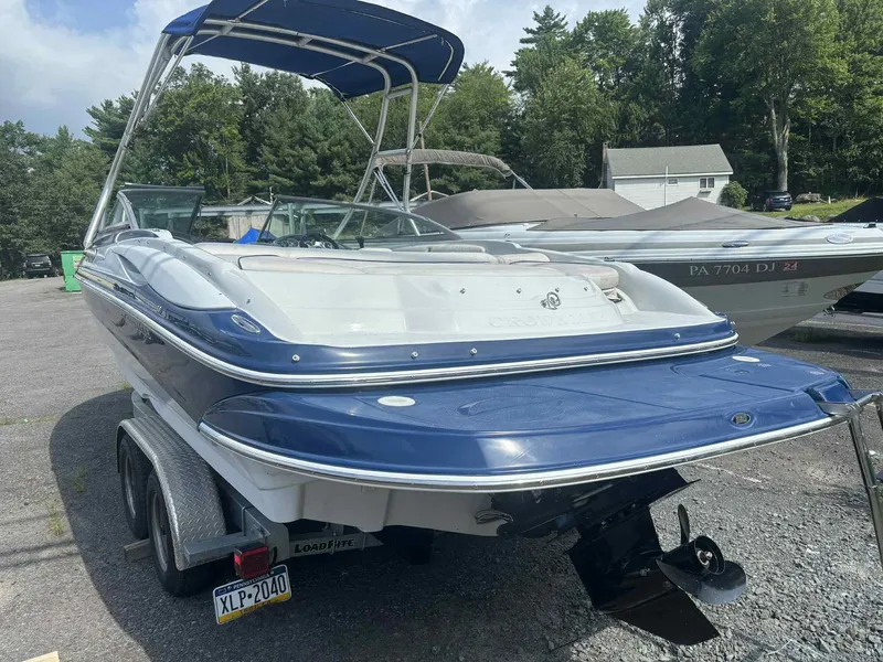Slide: The Image of 2006 Crownline 230LS boat with blue and white exterior on a trailer. - 3