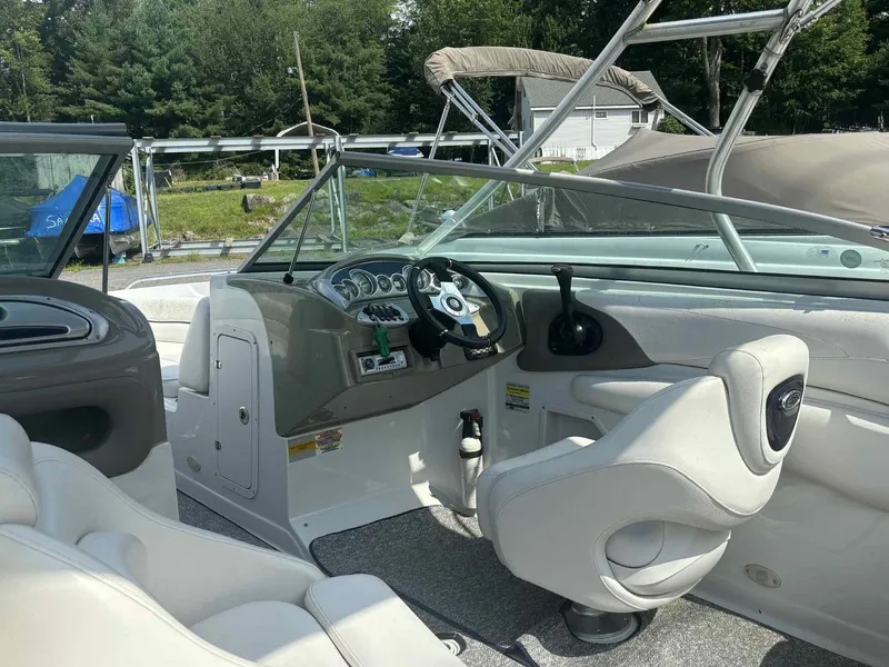 Slide: The Image of 2006 Crownline 230LS boat interior with steering wheel, seats, and dashboard controls. - 4