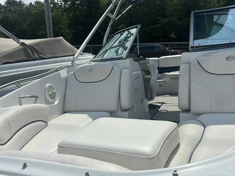 Slide: The Image of 2006 Crownline 230LS boat interior with white seating and open windshield. - 6
