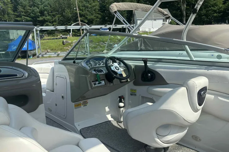 Slide: The Image of Interior of a 2006 Crownline 230 LS boat with steering wheel and seating. - 9