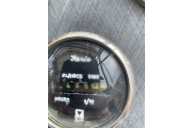 Slide: The Image of Close-up of a 1999 Sea Sport 2044 Walk Around engine hour meter displaying 4865 hours. - 10