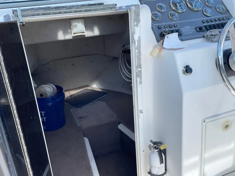 Slide: The Image of 1999 Sea Sport 2044 Walk Around boat interior with control panel and storage area. - 4