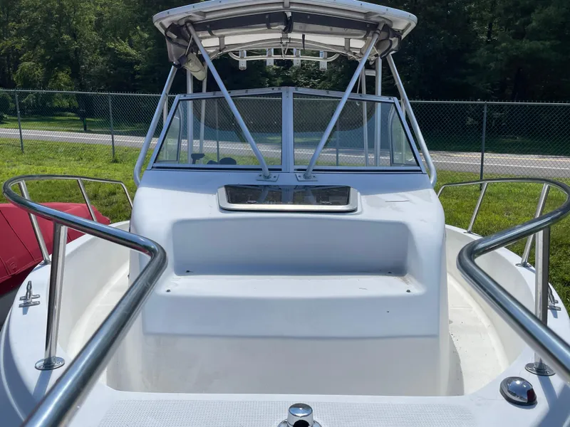 Slide: The Image of 1999 Sea Sport 2044 Walk Around boat, white exterior, docked outdoors. - 5