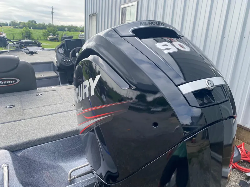 Slide: The Image of 2017 Triton 179 TrX boat with Mercury 90 outboard motor, parked near a building. - 10