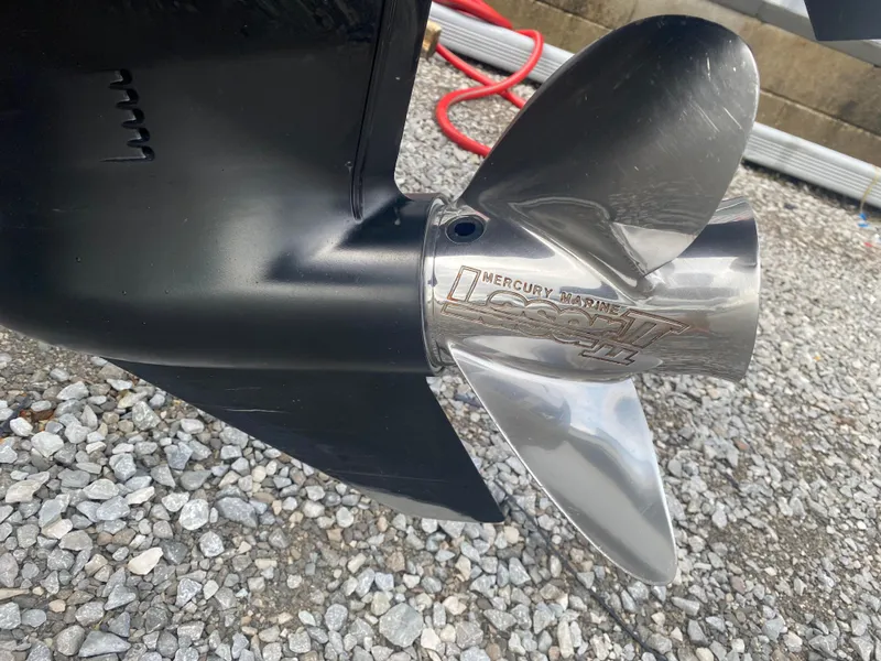 Slide: The Image of 2017 Triton 179 TrX boat propeller on gravel surface, featuring Mercury Marine branding. - 11