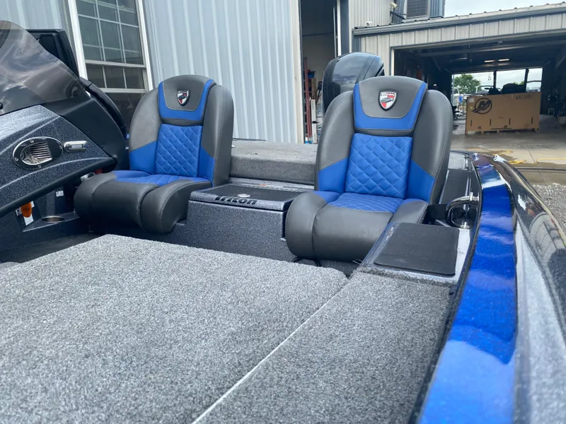 Slide: The Image of 2017 Triton 179 TrX boat interior with blue and gray seating. - 14