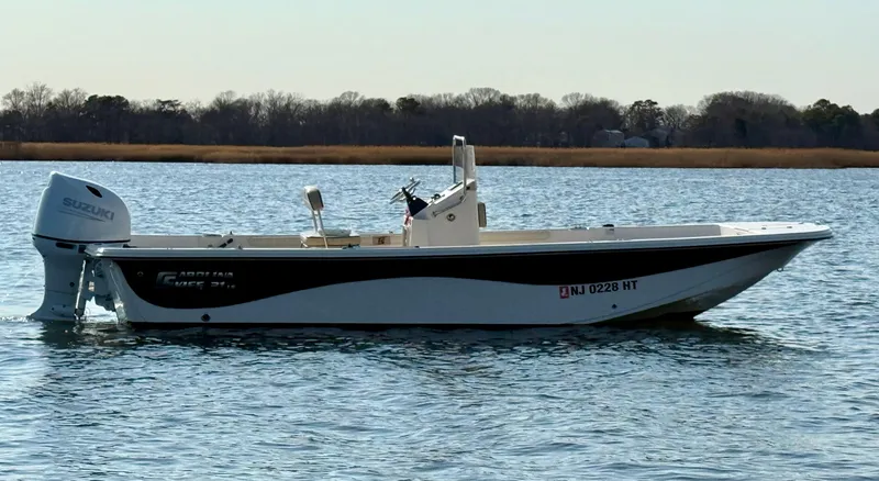 Slide: The Image of 2023 Carolina Skiff 21 LS boat on calm water, side view. - 1