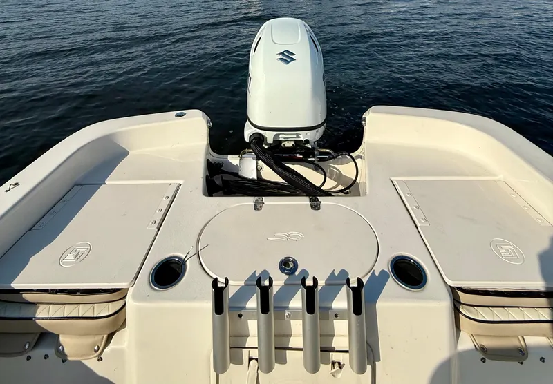 Slide: The Image of 2023 Carolina Skiff 21 LS boat with Suzuki outboard motor on calm water. - 12