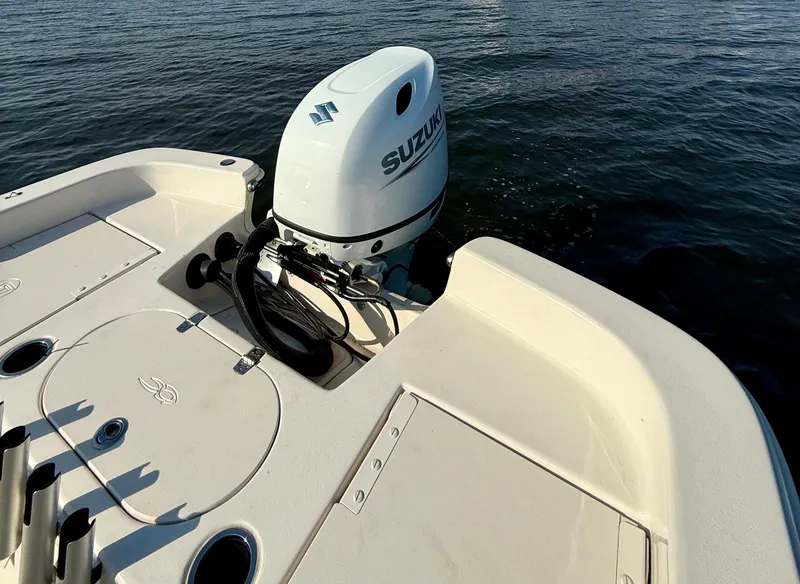 Slide: The Image of 2023 Carolina Skiff 21 LS boat with Suzuki outboard motor on calm water. - 13