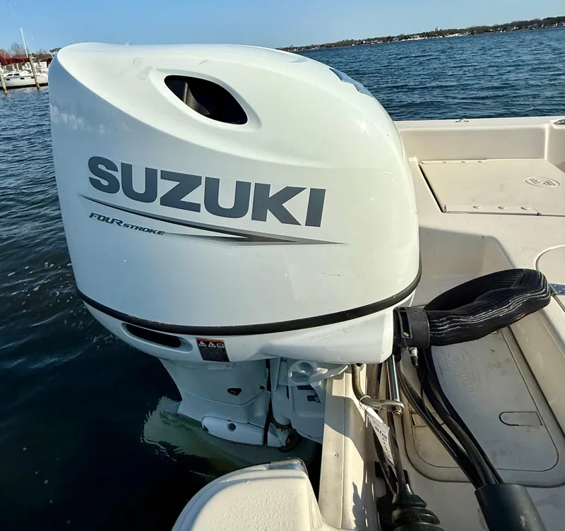 Slide: The Image of 2023 Carolina Skiff 21 LS with Suzuki outboard motor on water. - 14