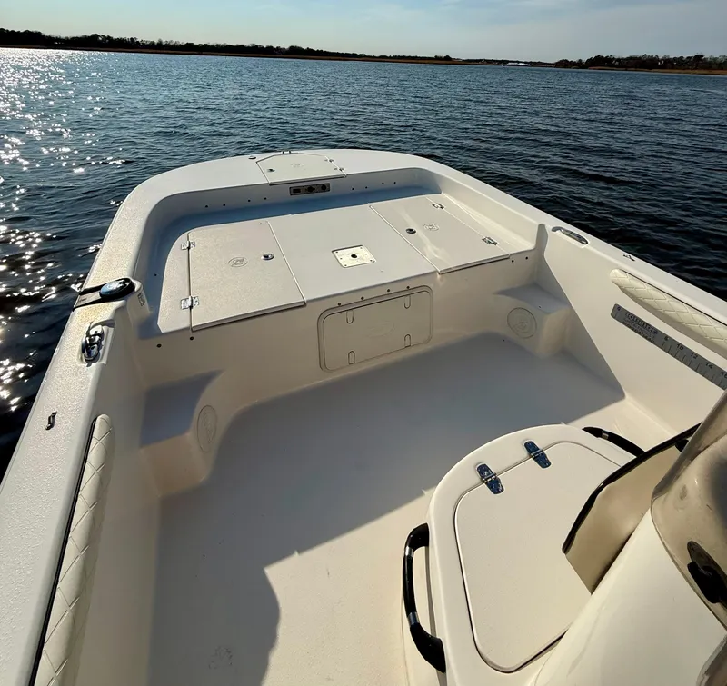 Slide: The Image of 2023 Carolina Skiff 21 LS boat on calm water, showcasing spacious deck. - 16