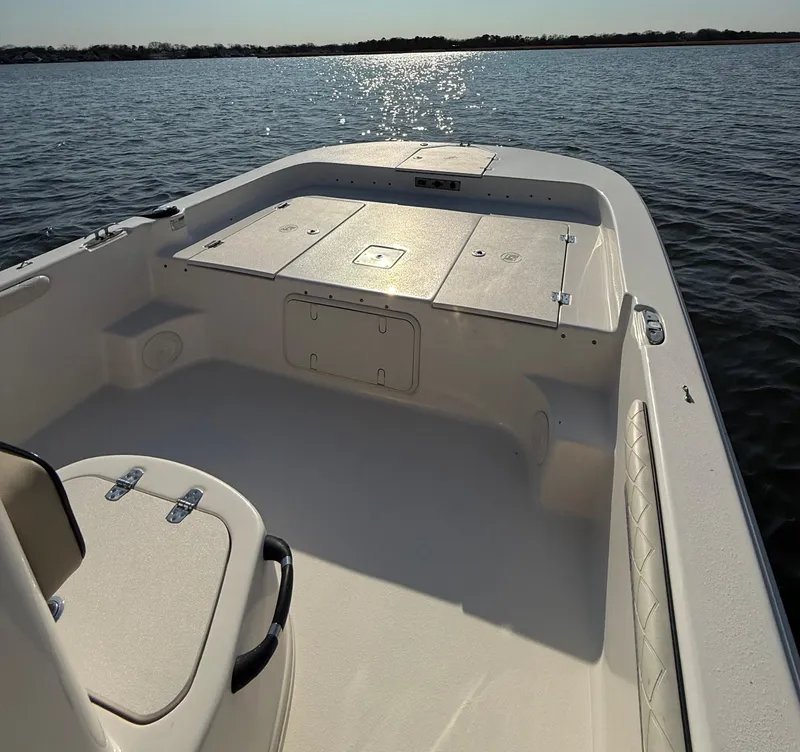 Slide: The Image of 2023 Carolina Skiff 21 LS boat interior on calm water, showcasing spacious deck. - 17