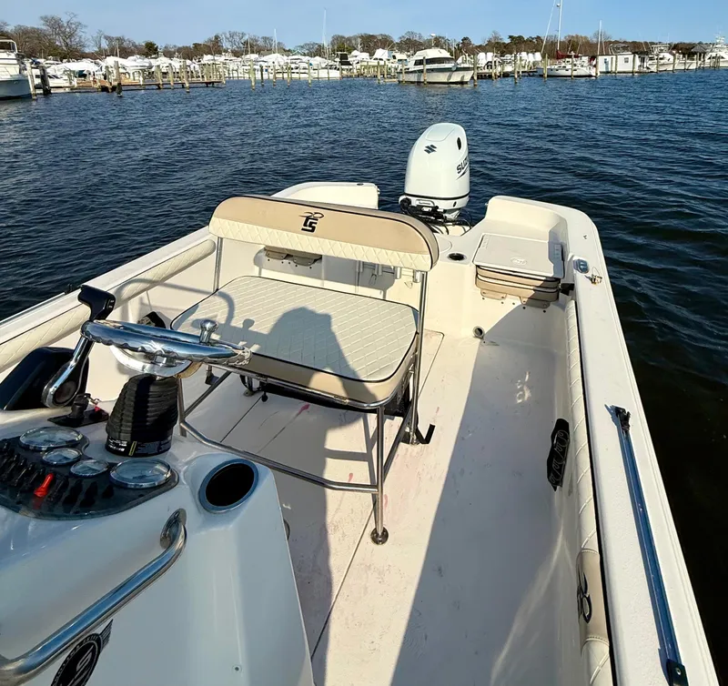 Slide: The Image of 2023 Carolina Skiff 21 LS boat on water, featuring seating and control console. - 6