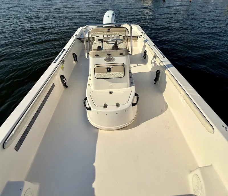 Slide: The Image of 2023 Carolina Skiff 21 LS boat on water, spacious deck, center console. - 9
