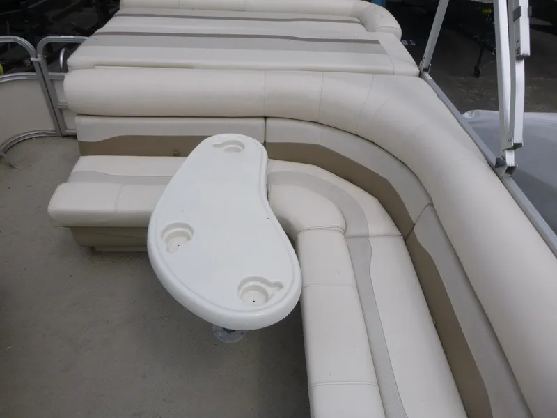 Slide: The Image of 2007 Smoker Craft M-8520 Cruise RE boat interior with beige seating and a white table. - 11