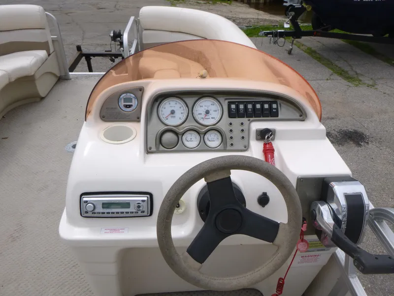 Slide: The Image of 2007 Smoker Craft M-8520 Cruise RE boat dashboard with steering wheel and gauges. - 8