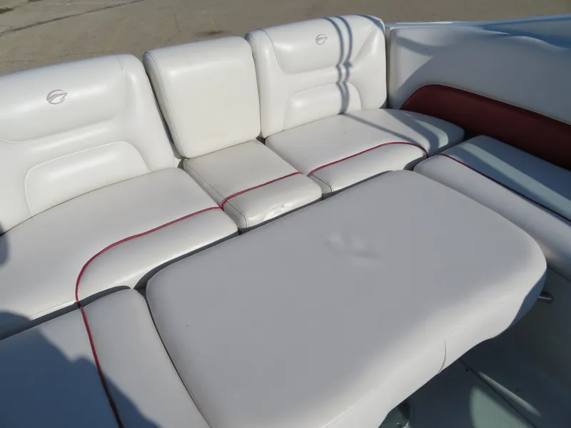 Slide: The Image of 2012 Crownline 275 SS boat interior with white cushioned seating and red accents. - 22