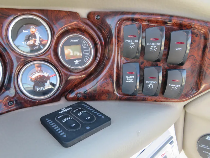 Slide: The Image of Dashboard controls of a 2012 Crownline 275 SS boat, featuring gauges and switches. - 25