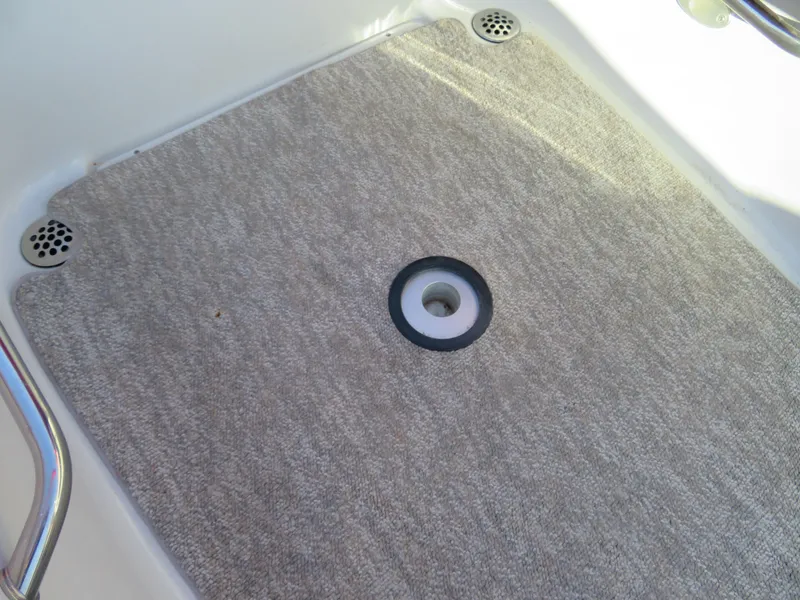 Slide: The Image of Carpeted deck of a 2012 Crownline 275 SS boat with metal fixtures. - 27