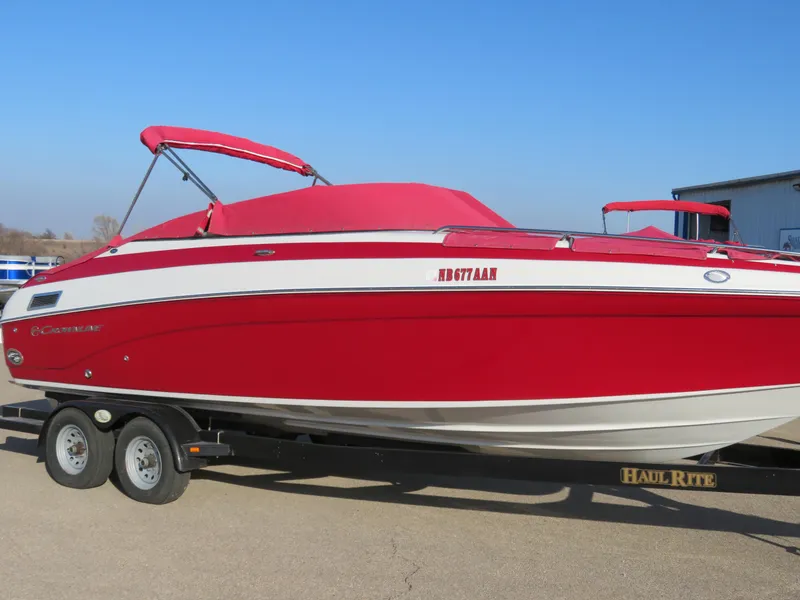 Slide: The Image of 2012 Crownline 275 SS boat in red on a trailer, sunny day. - 28