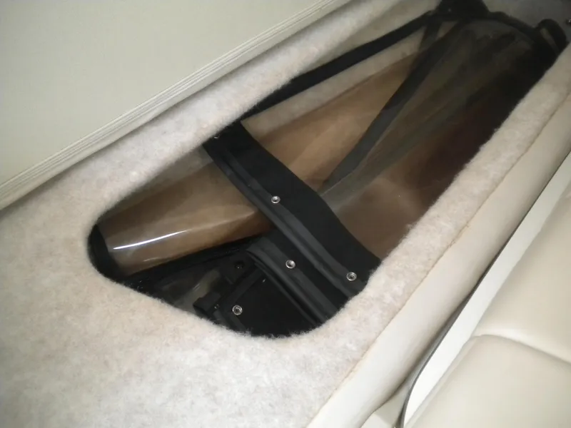 Slide: The Image of Storage compartment in a 2002 Formula 330 SS boat, featuring a clear cover. - 16