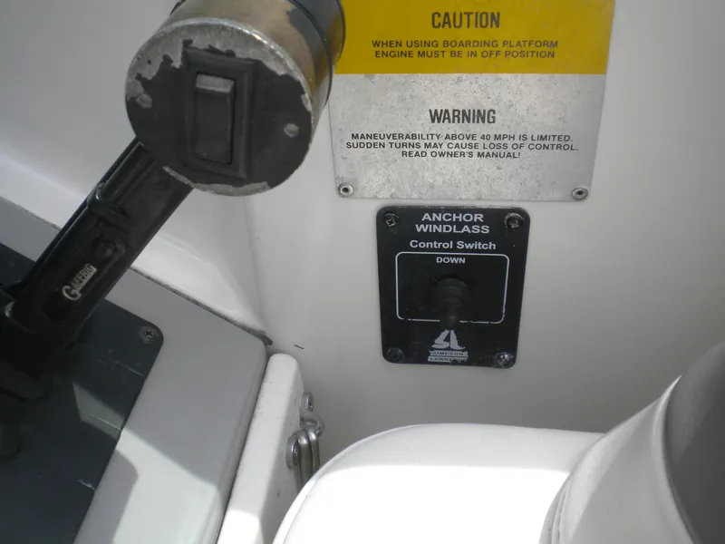 Slide: The Image of Control panel of a 2002 Formula 330 SS boat with anchor windlass switch and caution labels. - 18