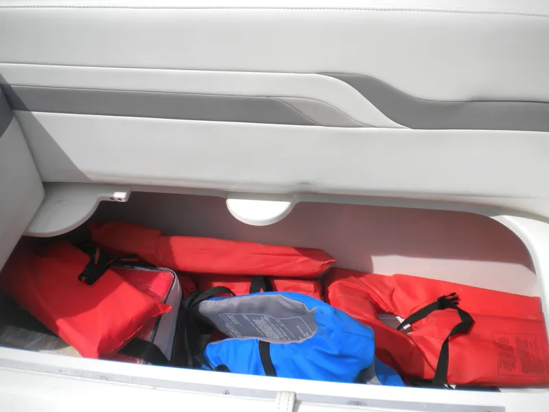 Slide: The Image of Storage compartment with life jackets in a 2002 Formula 330 SS boat. - 19