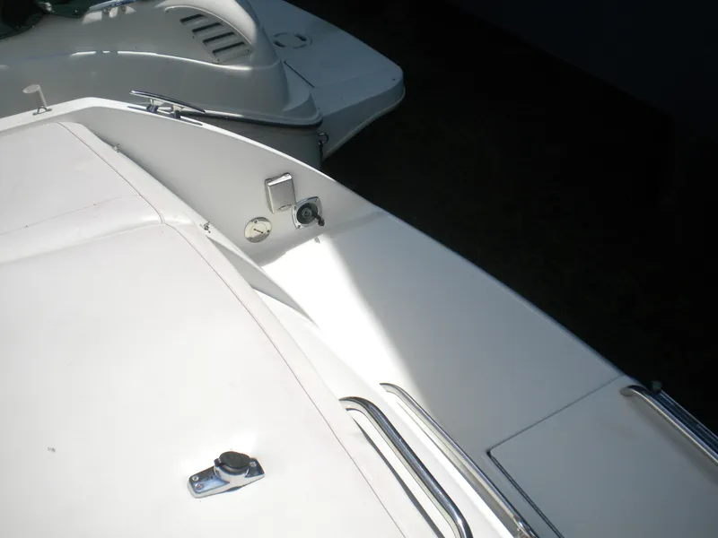 Slide: The Image of 2002 Formula 330 SS boat deck with sleek white surface and chrome details. - 21