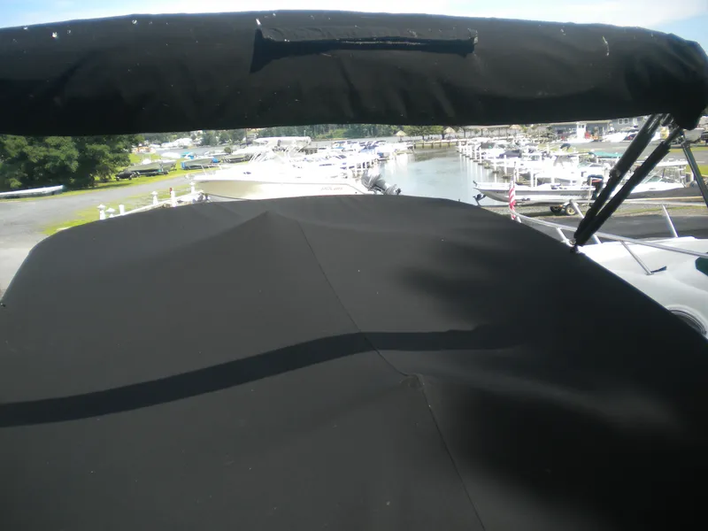 Slide: The Image of 2002 Formula 330 SS boat with black canopy at marina. - 3