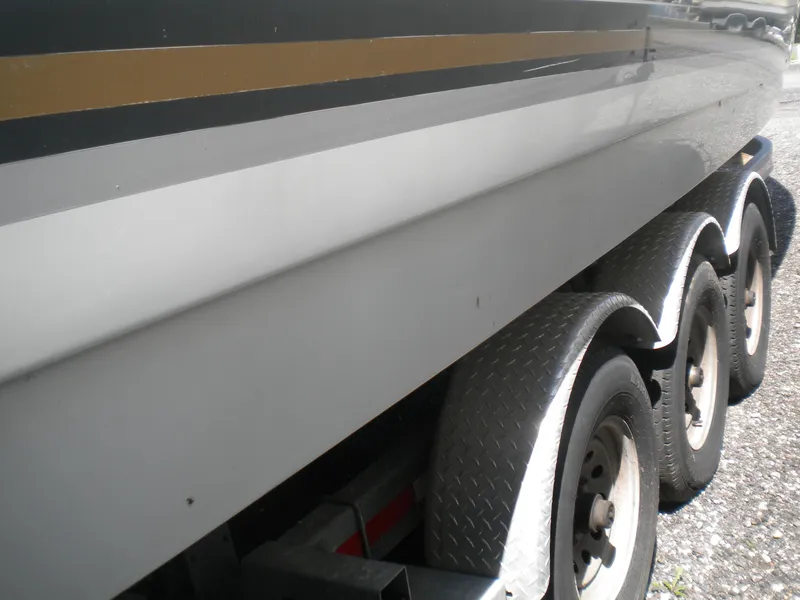 Slide: The Image of 2002 Formula 330 SS boat on a triple-axle trailer, side view. - 31