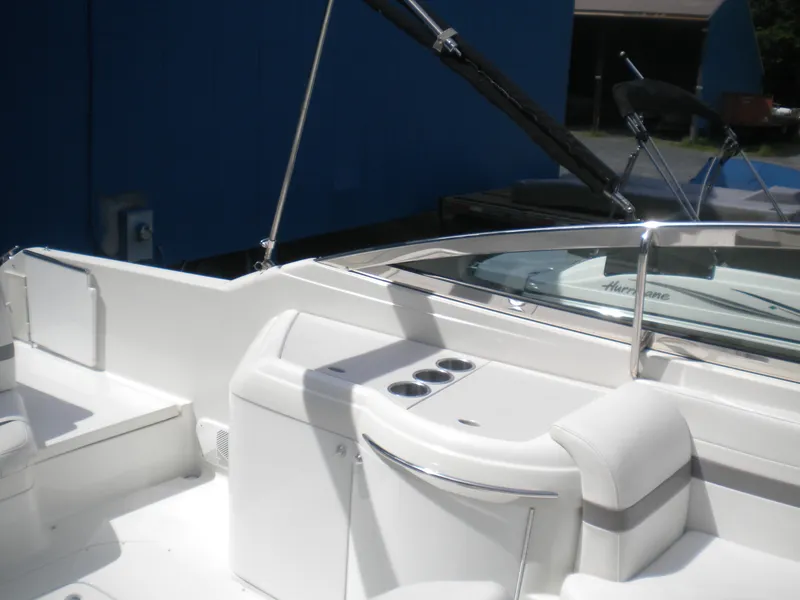 Slide: The Image of 2002 Formula 330 SS boat interior with white seating and cup holders. - 6