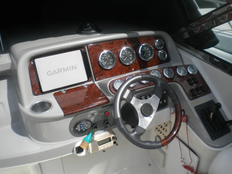 Slide: The Image of 2002 Formula 330 SS boat dashboard with Garmin navigation and wood accents. - 7