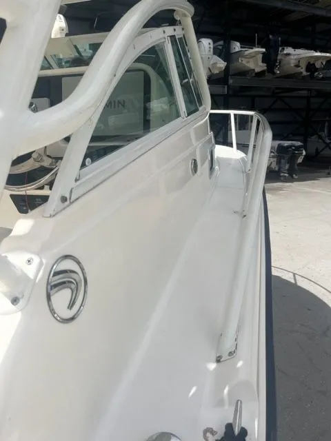 Slide: The Image of 2008 Edgewater 265 Express boat side view in a storage facility. - 16