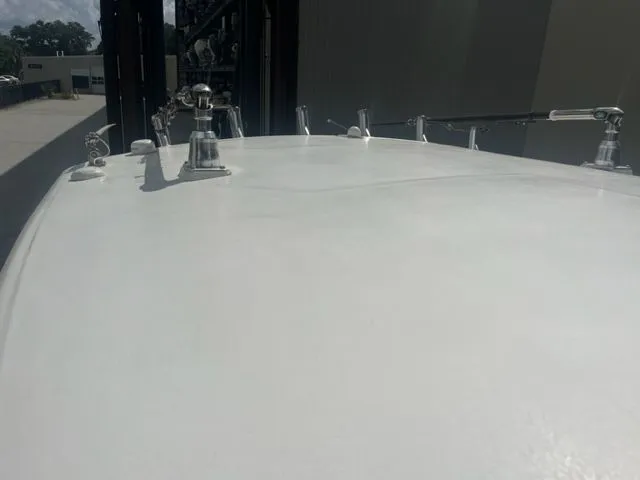 Slide: The Image of 2008 Edgewater 265 Express boat deck with metal fixtures in a storage facility. - 21