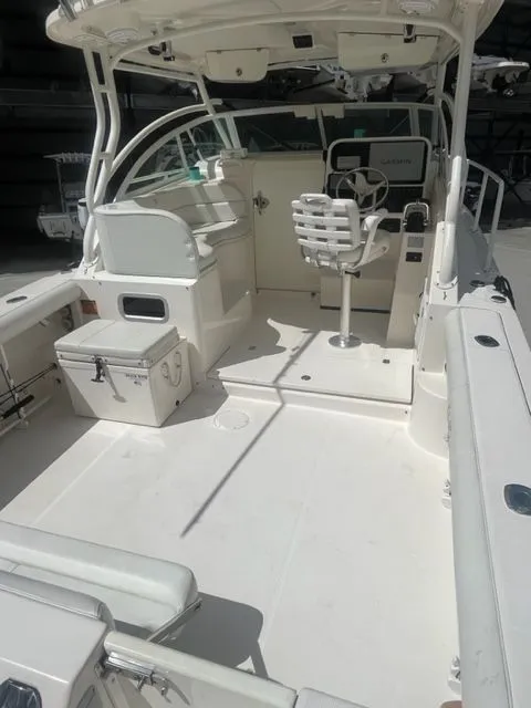Slide: The Image of 2008 Edgewater 265 Express boat interior with helm, seating, and storage compartments. - 5