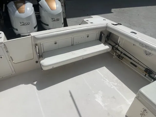 Slide: The Image of 2008 Edgewater 265 Express boat interior with twin 250 engines and foldable seating. - 6
