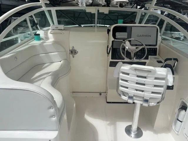 Slide: The Image of 2008 Edgewater 265 Express boat interior with Garmin navigation system and white seating. - 8