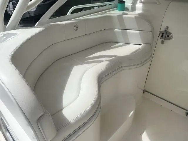 Slide: The Image of Luxurious white seating on a 2008 Edgewater 265 Express boat interior. - 9
