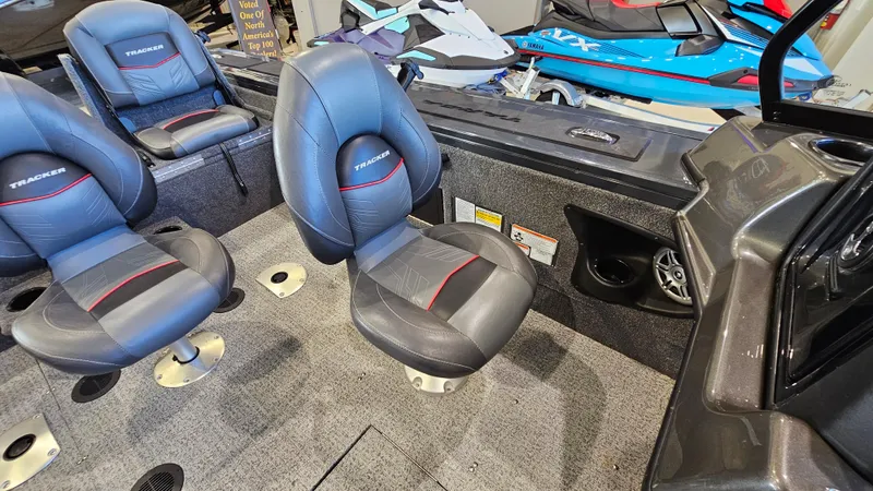 Slide: The Image of 2021 Tracker Targa V-18 Combo boat interior with gray seats and dashboard. - 10
