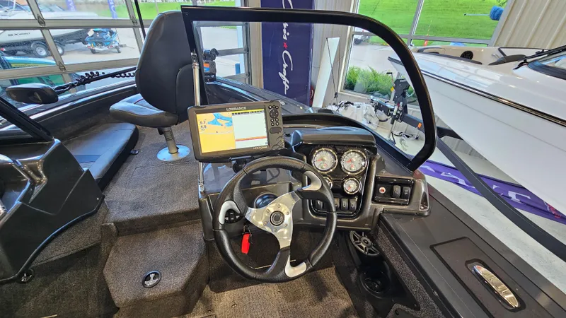 Slide: The Image of 2021 Tracker Targa V-18 Combo boat dashboard with steering wheel and navigation system. - 11