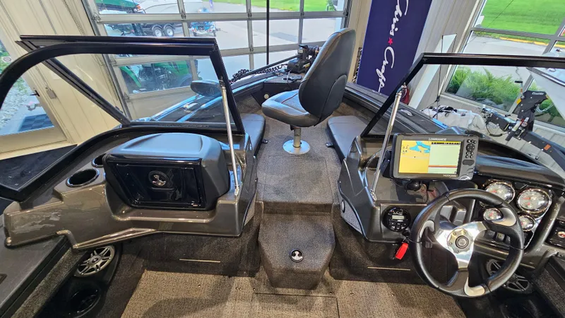 Slide: The Image of 2021 Tracker Targa V-18 Combo boat interior with steering wheel and navigation system. - 13