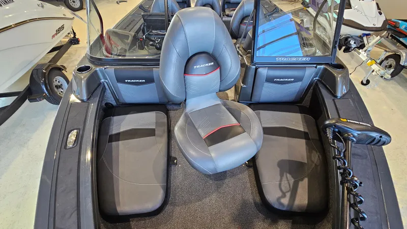 Slide: The Image of 2021 Tracker Targa V-18 Combo boat interior with gray seating and windshield. - 14