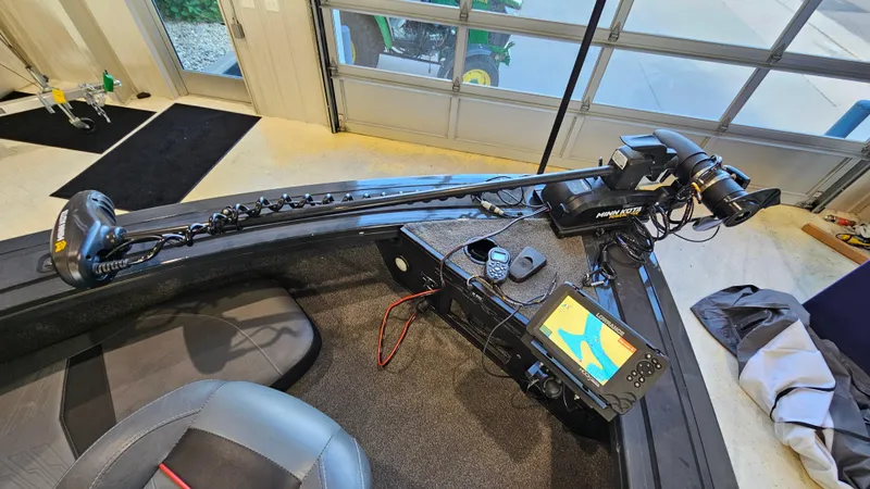 Slide: The Image of 2021 Tracker Targa V-18 Combo boat with advanced navigation and fishing equipment in a garage. - 15