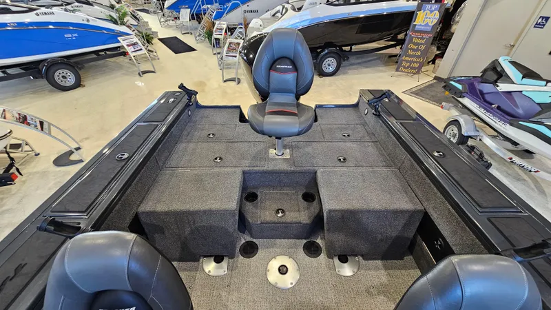 Slide: The Image of 2021 Tracker Targa V-18 Combo boat interior with seating and storage in showroom. - 18