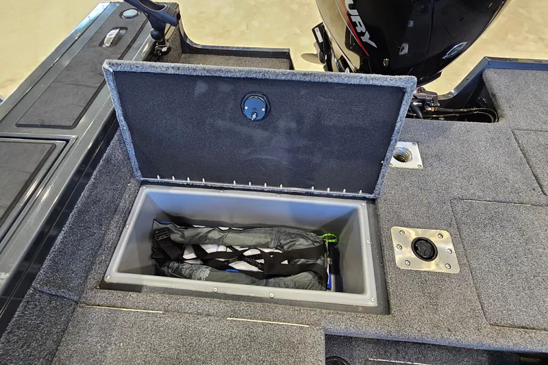Slide: The Image of 2021 Tracker Targa V-18 Combo boat storage compartment with gear inside. - 21