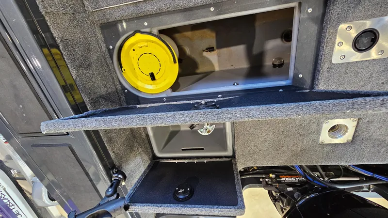 Slide: The Image of Interior compartments of a 2021 Tracker Targa V-18 Combo boat, featuring storage and access panels. - 22