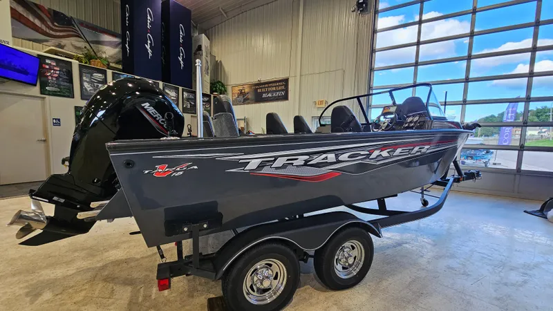 Slide: The Image of 2021 Tracker Targa V-18 Combo boat displayed indoors with trailer. - 3